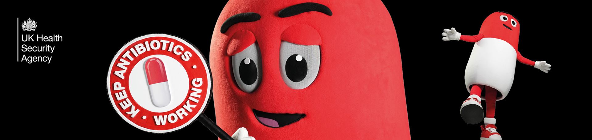 A red and white antibiotic tablet stands on one leg